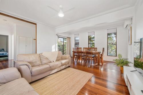 a living room with a couch and a table at Dusties 5 Pacific Street South West Rocks - Full Linen Provided in South West Rocks