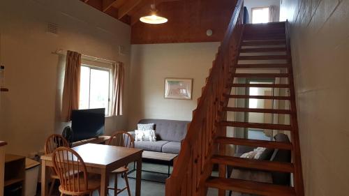 a living room with a staircase leading to a living room at Billungar Unit 2 at Hat Head - 21 Creek Street in Hat Head