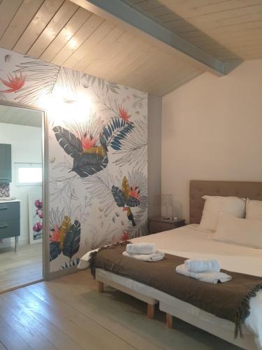 - une chambre avec un grand lit et une fresque murale dans l'établissement La Villa Michèle, domaine sur les hauteurs de Pézenas, à Pézenas
