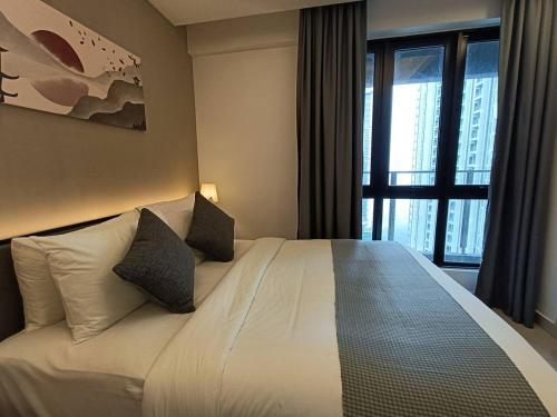 a bedroom with a bed with pillows and a window at Genting Peak 2BR6Pax421 @Ion Delemen in Genting Highlands