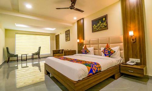 a bedroom with a large bed and a desk and chair at FabHotel Regency K9 Model Town in Jalandhar