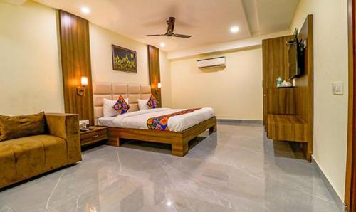 a bedroom with a bed and a couch at FabHotel Regency K9 Model Town in Jalandhar