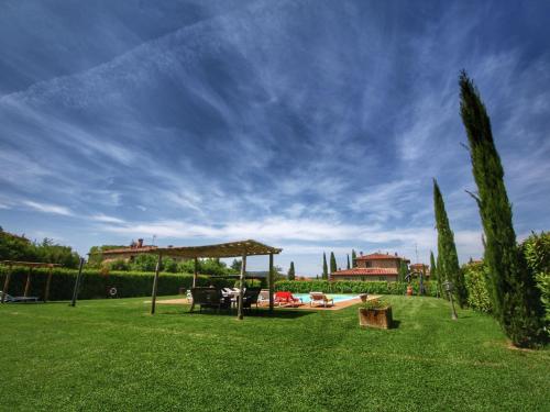 a garden with a gazebo on a green lawn at Luxurious apartment in Lucignano with views in Lucignano