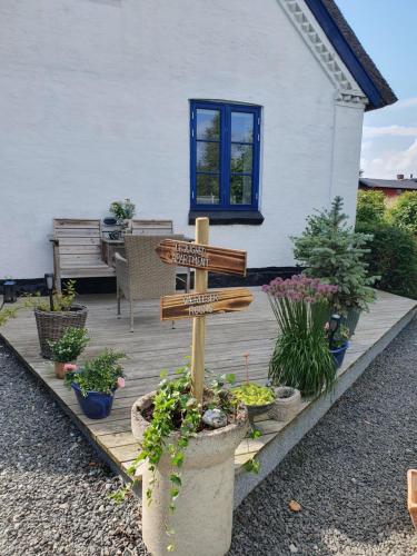 a wooden sign in front of a house at Pegasus Bed & Breakfast in Hillerød