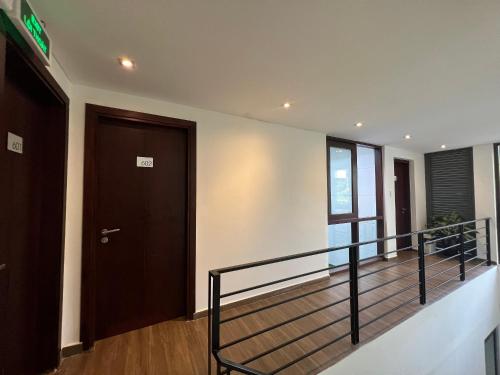 a hallway with a staircase with a door and a balcony at Em's House Hoi An Homestay in Hoi An