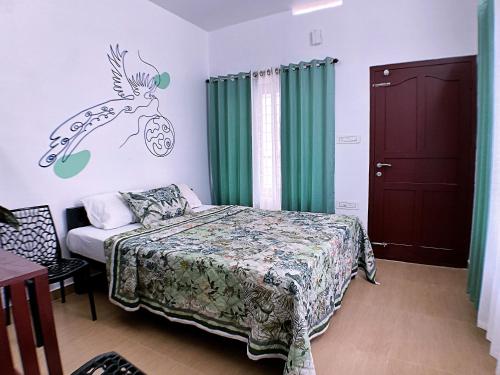 a bedroom with a bed with a deer decal on the wall at Moon Wings Mountain Resort in Kanthalloor