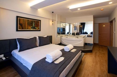 a bedroom with a large bed and a bath tub at Kanarya Suite in Istanbul