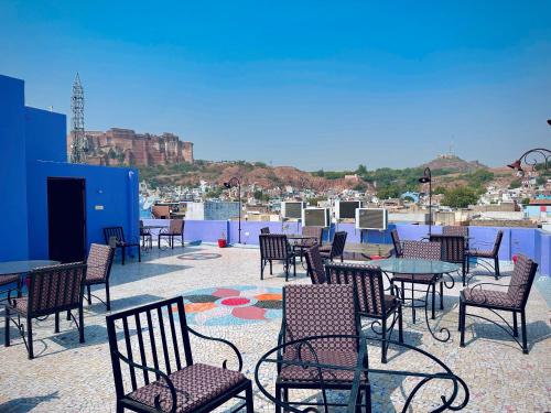 a group of chairs and tables on a roof at the new view in Jodhpur