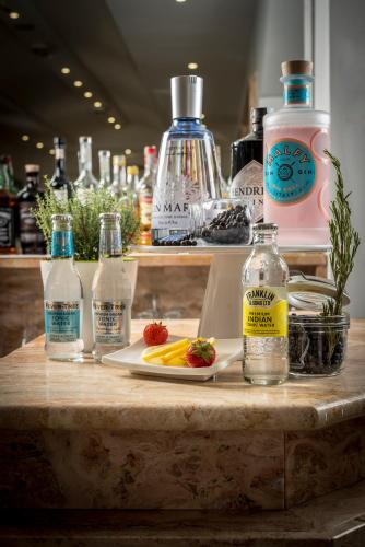 a table with a plate of fruit and bottles of water at Hotel Ascot Riccione in Riccione