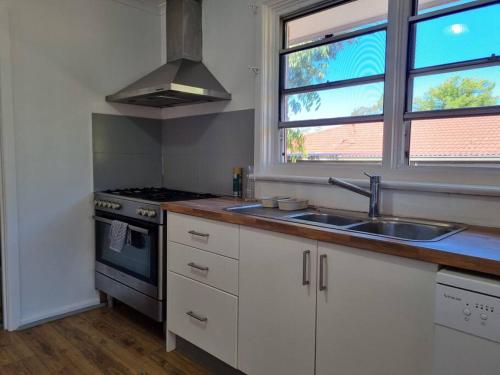 a kitchen with a sink and a stove at Close to nature, close to city in Kingston 