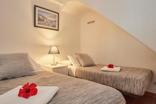 カブリルスにあるARTS HOUSE - Cabrils, Maresme, Barcelonaのベッドルーム1室(赤い花のベッド2台付)