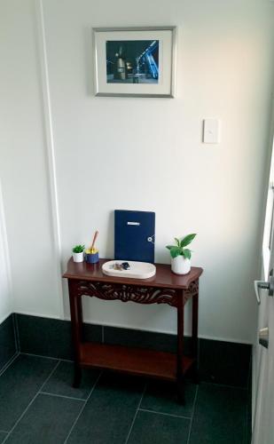 a small table with a picture on a wall at West End Studio 3 in Brisbane