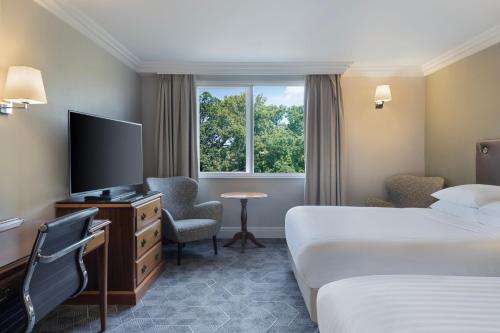 um quarto de hotel com duas camas e uma televisão em Delta Hotels by Marriott Huntingdon em Huntingdon