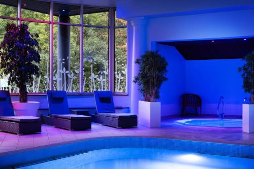 a swimming pool with blue lights in a building at Delta Hotels by Marriott Huntingdon in Huntingdon
