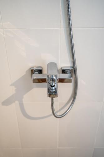 a shower in a bathroom with a hose at The babakan accommodations in Sidemen