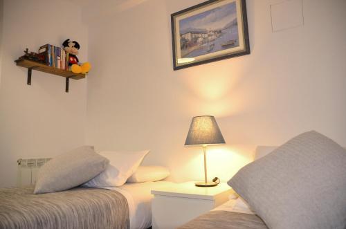 a bedroom with two beds and a lamp on a table at ARTS HOUSE - Cabrils, Maresme, Barcelona in Cabrils
