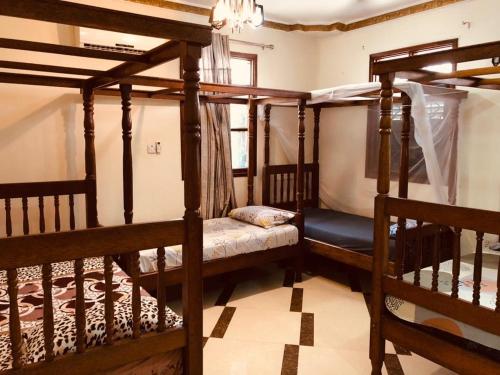 a room with two bunk beds and a window at Sawa Sawa Apartment in Ngambo