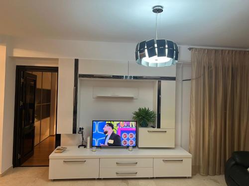 a living room with a tv on top of a dresser at Luxury Copou Apartments in Iaşi