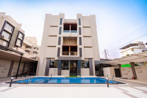 a building with a swimming pool in front of a building at Regenta Place Igatpuri in Igatpuri
