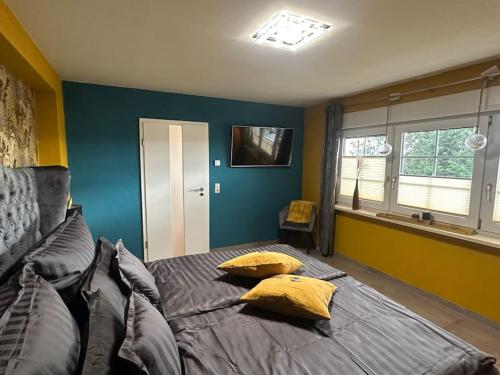 a bedroom with a bed with yellow pillows on it at Palais -MehrGehtNicht-Maisonette in Großweitzschen