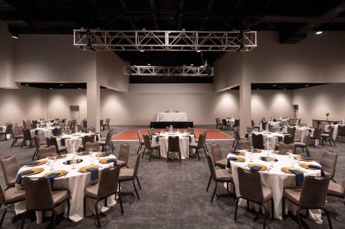 a banquet hall with white tables and chairs at Palm Beach Gardens Marriott in Palm Beach Gardens