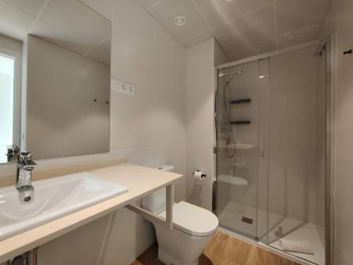 a white bathroom with a sink and a shower at Mr luxury Born 1BR Apartment With Balcony in Barcelona