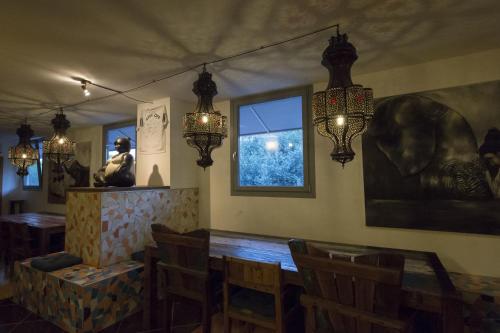 a dining room with a table and chairs and lights at Hotel Antares Sport Beauty & Wellness in Villafranca di Verona