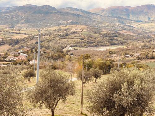 a view of a valley with trees and mountains at Matteo's House in Penne