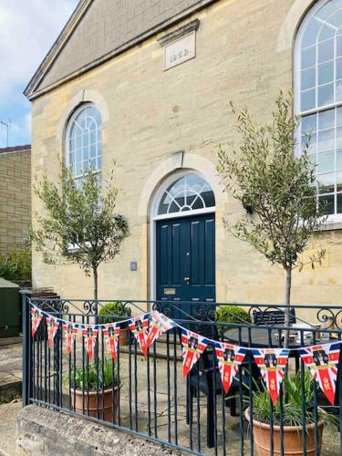a church with british flags hanging on a fence at 3 bedroom converted chapel in historic Oundle in Oundle