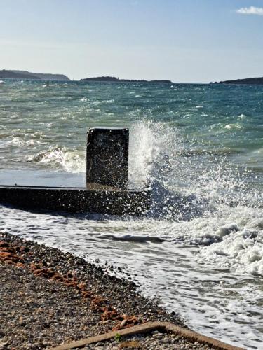 a wave breaking on the shore of a beach at Apartment Lupo in Vodnjan