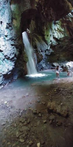 a person standing in front of a waterfall at Relax in Casa Domi in Scalea