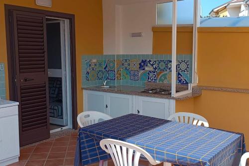 a kitchen with a table and chairs and a counter at Relax in Casa Domi in Scalea