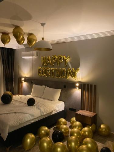 a bedroom with a bed with a happy birthday sign at Del Mare Park in Kérynia