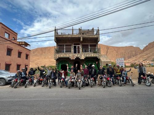 a group of people on motorcycles in front of a building at La Petite Gorge, Hôtel & Restaurant Todra Gorge in Tinerhir