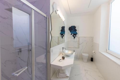 a bathroom with a shower and a sink and a toilet at Suite Dreams Montecatini in Montecatini Terme
