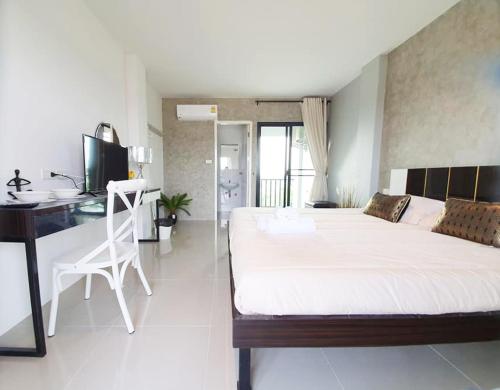 Ένα ή περισσότερα κρεβάτια σε δωμάτιο στο Samutsakorn Condo