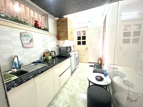 a small kitchen with a sink and a table at Kolor Home/2Brs/Near Hoankiem Lake/Old Quarter in Hanoi