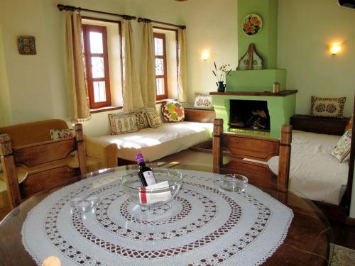 a living room with a table with a bottle of wine at Guesthouse Kontogianni - Materka in Nymfaio