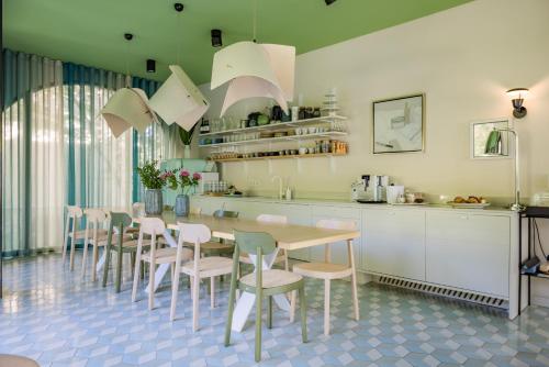 a kitchen with a table and chairs in a kitchen at Bagatelle Gardenhouse in Budapest