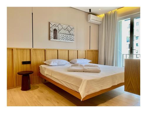 a bedroom with a bed with two pillows on it at Deluxe Apartment in Tashkent