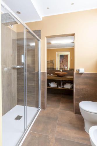 a bathroom with a shower and a toilet and a sink at Suite Dreams Montecatini in Montecatini Terme