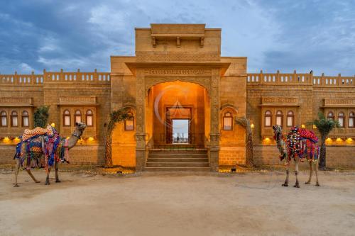 a building with two camel statues in front of it at Golden Star Desert Camp in Jaisalmer