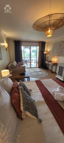a room with two beds and a living room at Studio Sable 2/4 pers face à la mer in Sainte-Anne