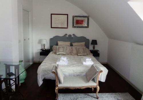 a bedroom with a large bed with a chair at Ca' Marconi in San Donà di Piave