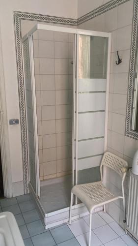 a shower with a chair in a bathroom at Colosseum Point in Rome