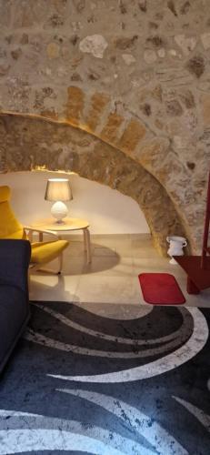 uma sala de estar com um sofá e uma mesa em casa vacanze Nonna Maria em Caltagirone