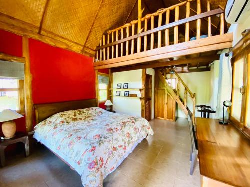 a bedroom with a bed and a wooden staircase at At Home Chiang Dao, Pooch Lovers in Ban Tham
