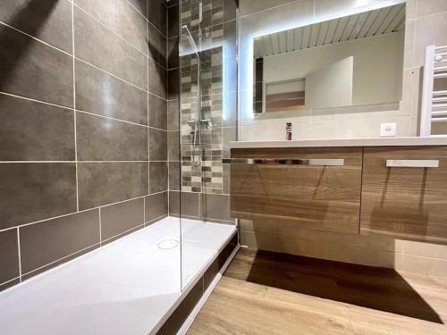 a bathroom with a glass shower and a sink at Montagn'Art Studio. 4pers 30m2. Coeur village. in Cauterets