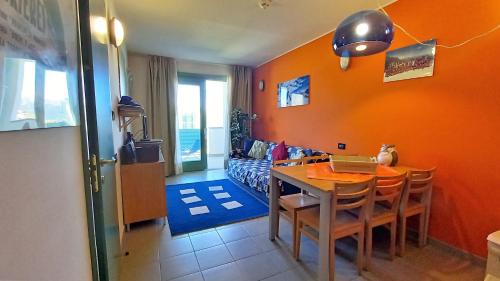 a dining room with a table with a laptop on it at villaggio olimpico in Sestriere