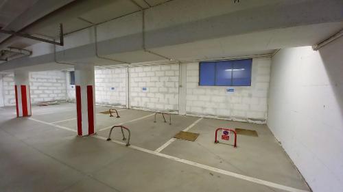 an empty parking garage with red and white walls at villaggio olimpico in Sestriere